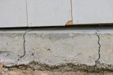 Concrete foundation with visible cracks, ideal for storm damage repair assessment.