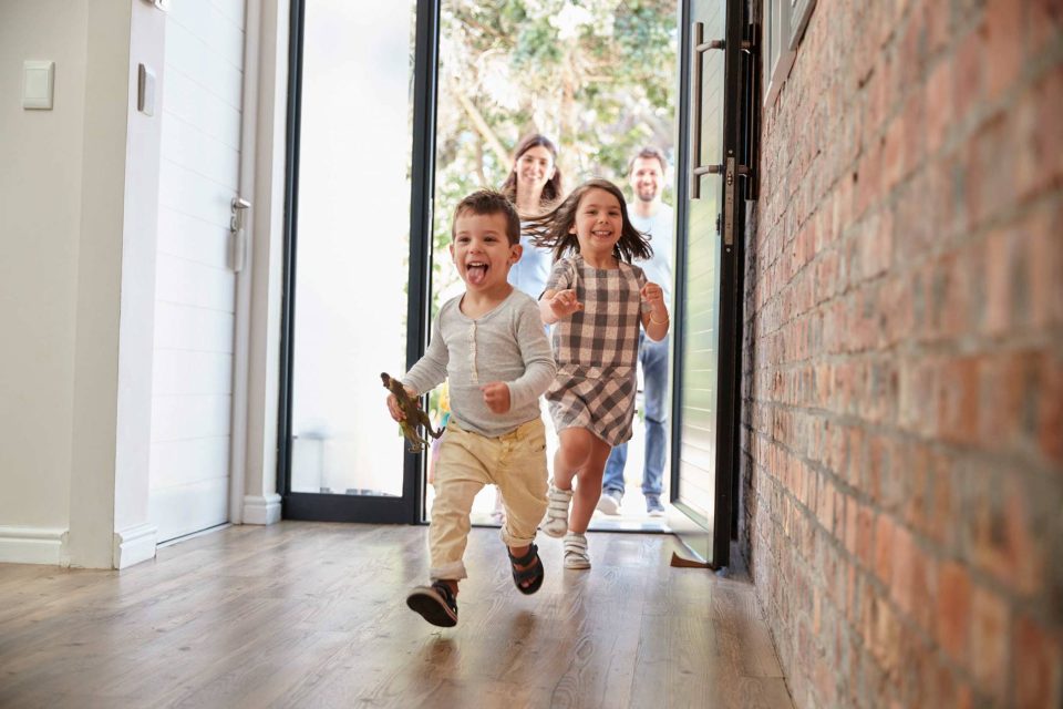 Children running indoors, adults smiling—best restoration companys magic.